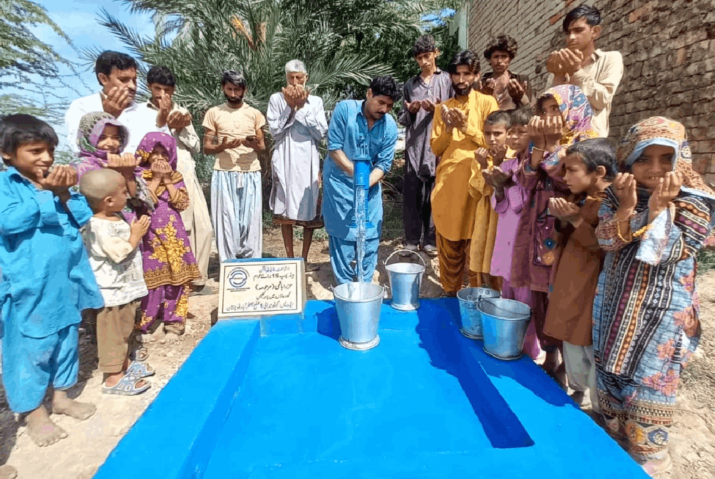 donations Community praying near the handpump donated by supporters.