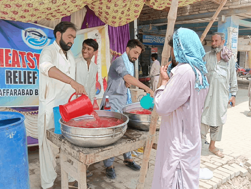 Volunteers distributing refreshing juices in extremely hot weather.