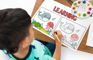 young child painting shows Early childhood education effects long term in learning and life.