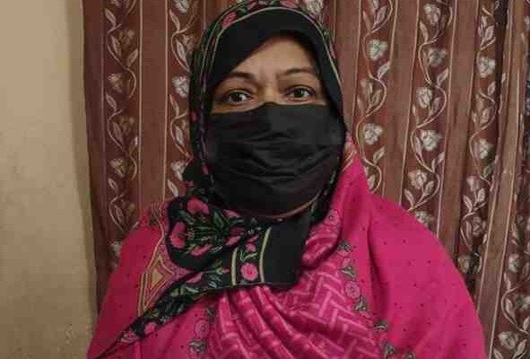 Widow support- A Journey of Hope and Strength A woman showing a certificate of Widow Support financial assistance.